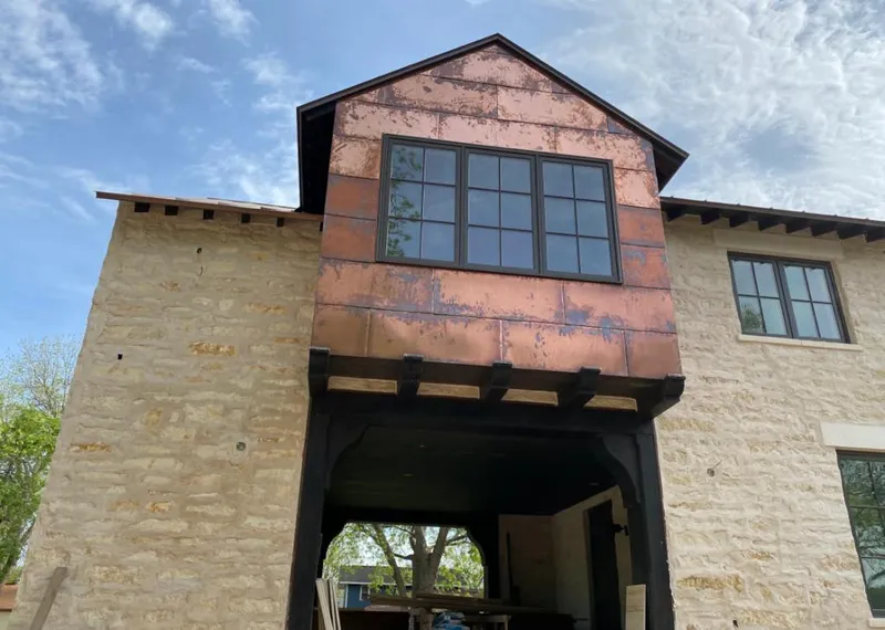Copper metal panel facade on a stone building for Skylight Installation in Oak Forest
