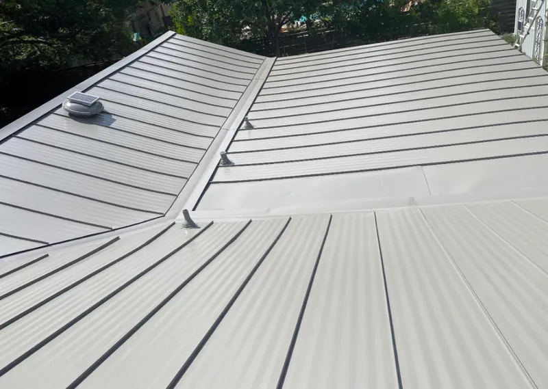 Solar attic fan installed on a metal roof for Roof Ventilation in Oak Forest